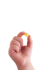 Child's hand holding a capsule of Omega 3 on white background. Close up. High resolution product. Health care concept.