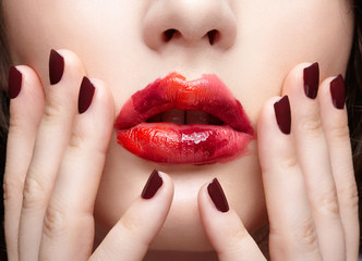Naklejka premium Brunette girl with unusual alyapy red female face makeup