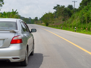 Close-up side of silver car parking on the road.