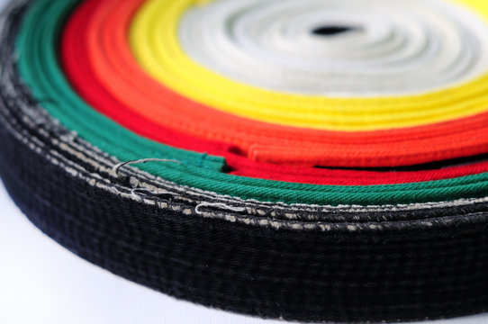 Zen set. Clothes for martial arts - karate, aikido, judo. Colored belts on a white background.