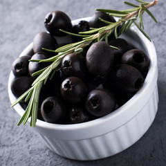 Black olive in a bowl.  Closeup