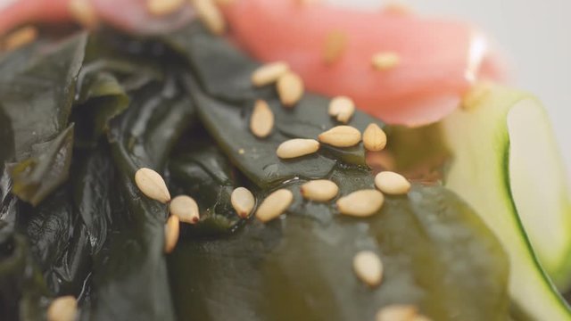 sesame seeds falling on japanese salad. Macro texture