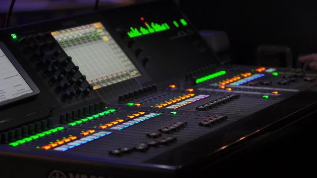 Mixing console at event, medium shot
