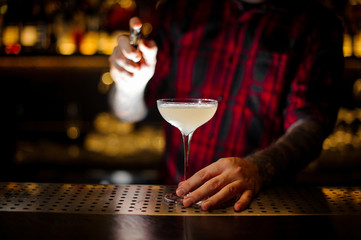 Bartender spraying on the Courpse Reviver cocktail from the vaporizer