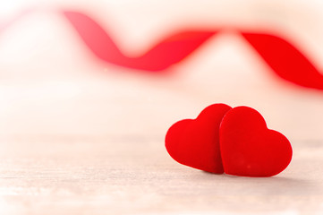 Fototapeta premium Concept of Valentine, anniversary, wedding celebration, heart shapes on a white wooden bench, bokeh background, close up