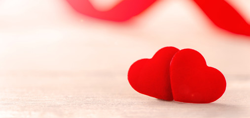 Fototapeta premium Concept of Valentine, anniversary, wedding celebration, heart shapes on a white wooden bench, bokeh background, close up