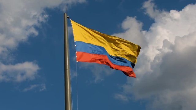Close smooth shot of Colombian flag in the wind, Strong wind moving Colombian flag in summer time in Medellin