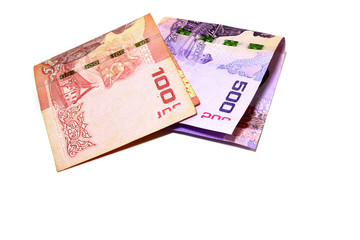 Thai banknotes in the amount of 100 baht and 500 baht. Fold overlapping on a white background.