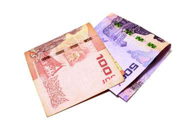 Thai banknotes in the amount of 100 baht and 500 baht. Fold overlapping on a white background.
