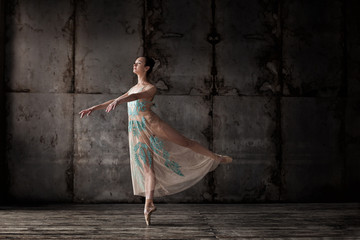 young beautiful ballet dancer in beige dress