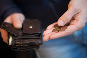Businessman hands holding black wallet with coins money
