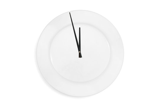 Top view of a empty serving plate as a clock with arrows on the white background. Concept. Isolated