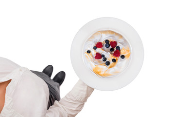 Top view of a waitress in a white blouse carrying plate with cake on the white background. Concept. Isolated