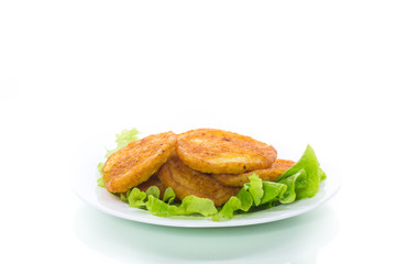 potato pancakes with lettuce leaves in a plate