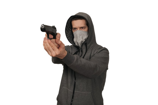 The man in a sports jacket and in a mask shoots with the gun