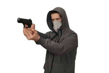 The man in a sports jacket and in a mask on a face shoots with the gun. White background