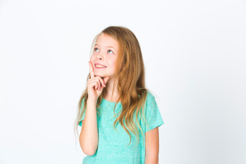 portrait of young pretty blonde girl thinking in front of white background
