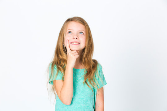 Portrait Of Young Pretty Blonde Girl Thinking In Front Of White Background