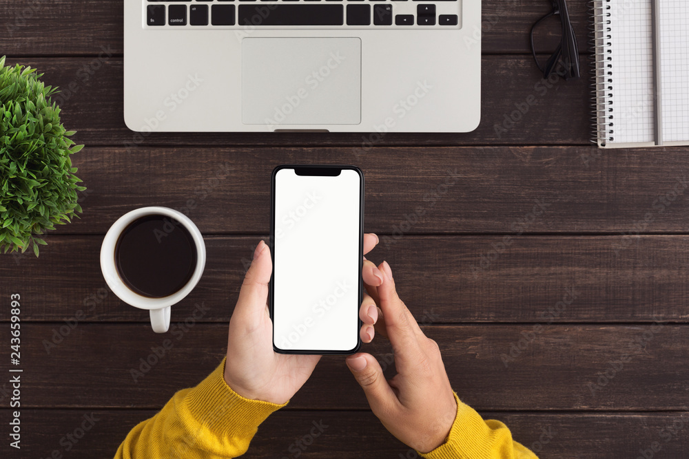 Poster designer working with blank smartphone in office