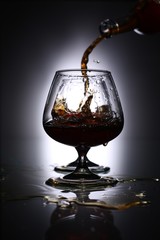 pouring brandy into a glass