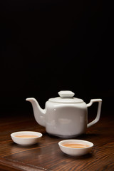 tea pot and cups with traditional chinese tea isolated on black with copy space