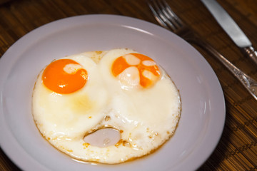 Two fried eggs on plate. Healthy breakfast.
