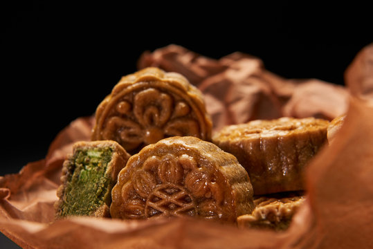selective focus of traditional chinese mooncakes isolated on black