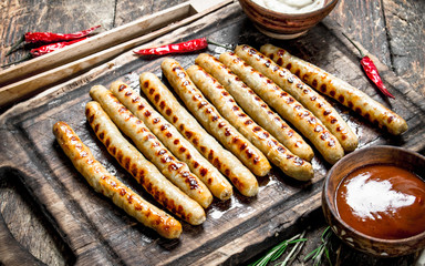 Grilled sausages with tomato sauce.