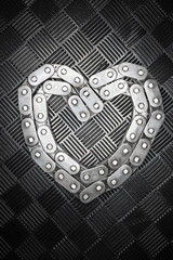 The metal heart from chain with combination love heart on the metal background. Concept for valentines day