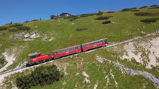 Rack railway train climbing to Schafberg summit in Salzkammergut, Upper Austria.