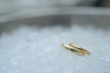 Obraz na płótnie Canvas Two wedding rings. Background ice