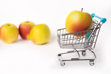 Healthy food and proper nutrition.  Apple in a shopping cart.