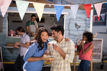 Man feeding snacks to woman