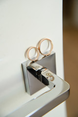 Gold wedding rings. The background of the door handle