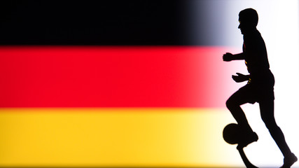 Fototapeta na wymiar Germany National Flag. Football, Soccer player Silhouette