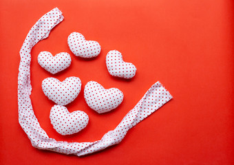Valentine's hearts on red background. top view
