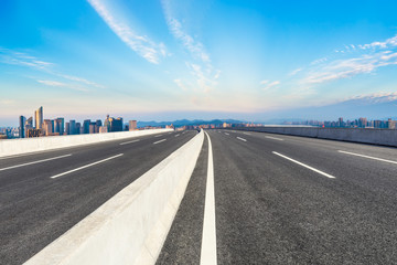 Fototapeta premium Empty asphalt road and city skyline at sunrise in hangzhou,high angle view