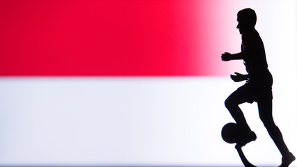 Fototapeta na wymiar Indonesia National Flag. Football, Soccer player Silhouette