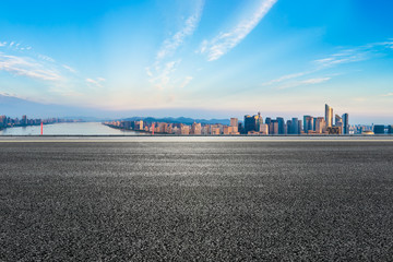 Empty asphalt road and city skyline at sunrise in hangzhou,high angle view