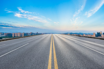 Empty asphalt road and city skyline at sunrise in hangzhou,high angle view