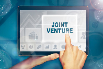 A hand selecting a Joint Venture business concept on a computer tablet screen with a colorful background.