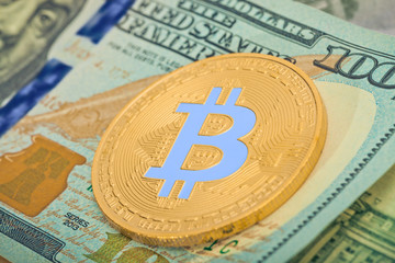 Hundred US dollars with golden bitcoin over it