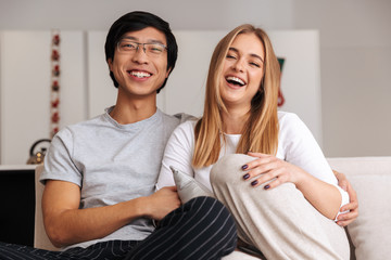 Cheerful young couple sitting together
