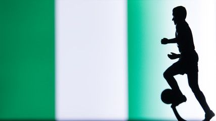 Fototapeta na wymiar Nigeria National Flag. Football, Soccer player Silhouette