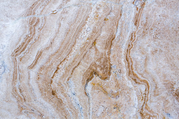 the texture of artificial marble is light natural beige with a beautiful pattern and dark inclusions.