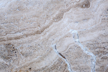 the texture of artificial marble is light natural beige with a beautiful pattern and dark inclusions.