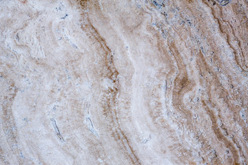 the texture of artificial marble is light natural beige with a beautiful pattern and dark inclusions.