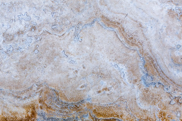 the texture of artificial marble is light natural beige with a beautiful pattern and dark inclusions.