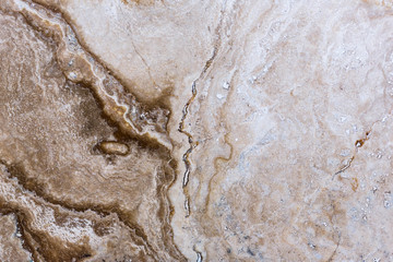 the texture of artificial marble is light natural beige with a beautiful pattern and dark inclusions.
