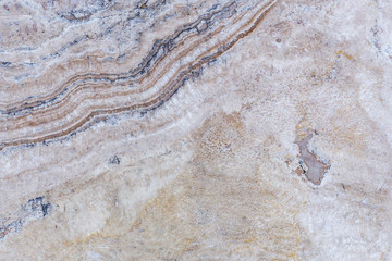 the texture of artificial marble is light natural beige with a beautiful pattern and dark inclusions.